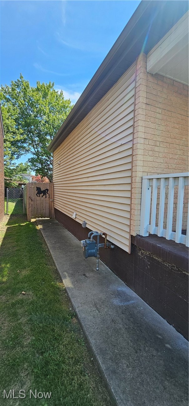 136 Mahan Road Weirton, WV 26062 - Photo 30 of 37 View of side of property featuring a gate and brick siding