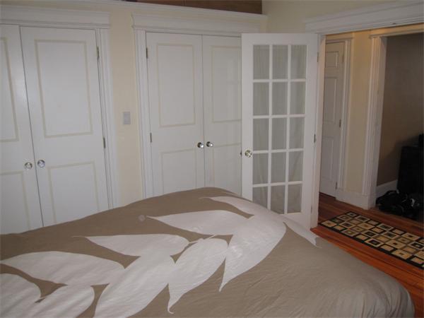 2 Colliston Road, Unit 4 Boston, MA 02135 - Photo 3 of 5 a bedroom with a bed and a flat screen tv