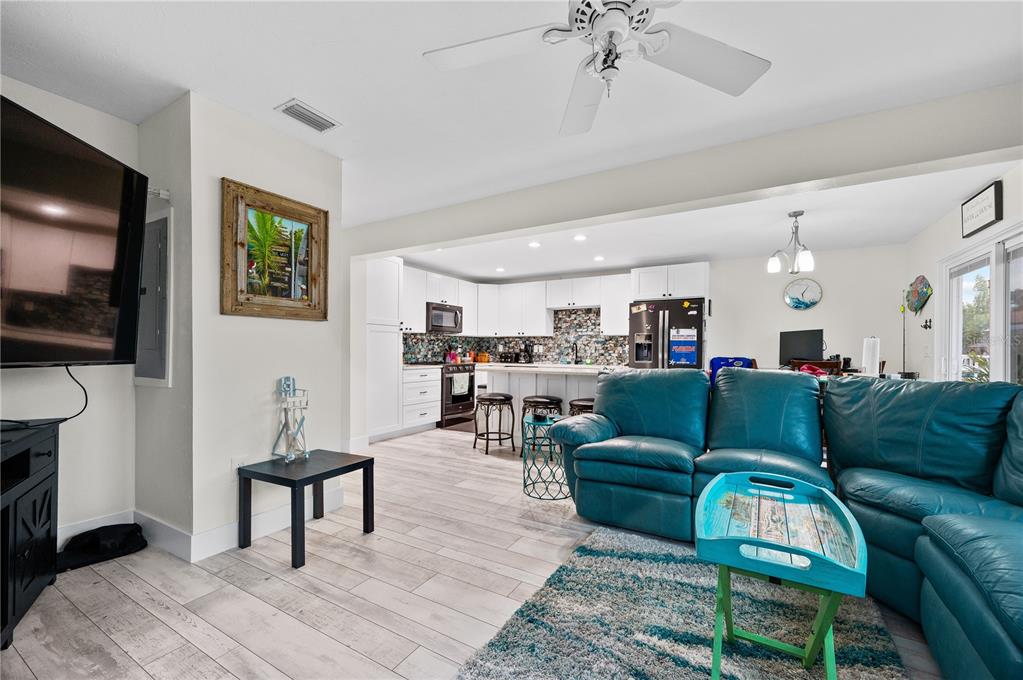 30 Southeast Valare Lane, Unit 102B Crystal River, FL 34429 - Photo 2 of 47 a living room with furniture and a flat screen tv
