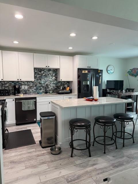 30 Southeast Valare Lane, Unit 102B Crystal River, FL 34429 - Photo 33 of 47 a kitchen with stainless steel appliances kitchen island granite countertop a table chairs sink and cabinets