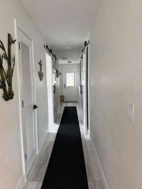 30 Southeast Valare Lane, Unit 102B Crystal River, FL 34429 - Photo 36 of 47 a view of a hallway with a black and white door