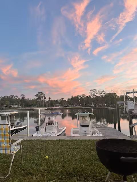 30 Southeast Valare Lane, Unit 102B Crystal River, FL 34429 - Photo 43 of 47 a view of a lake with a garden