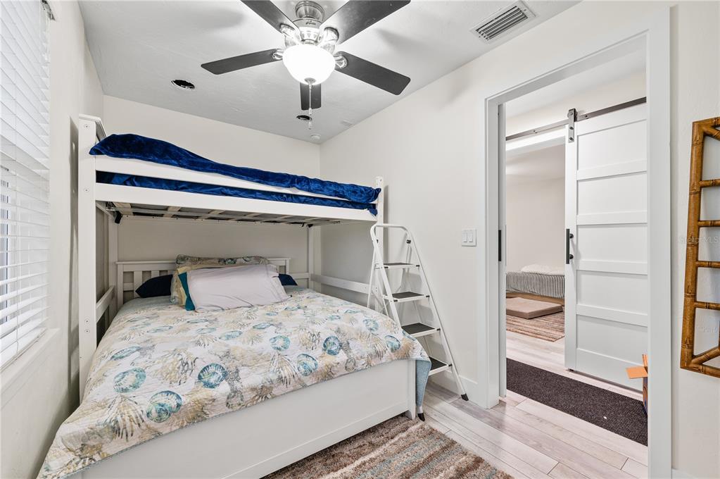 30 Southeast Valare Lane, Unit 102B Crystal River, FL 34429 - Photo 5 of 47 a bedroom with a large bed and a chandelier
