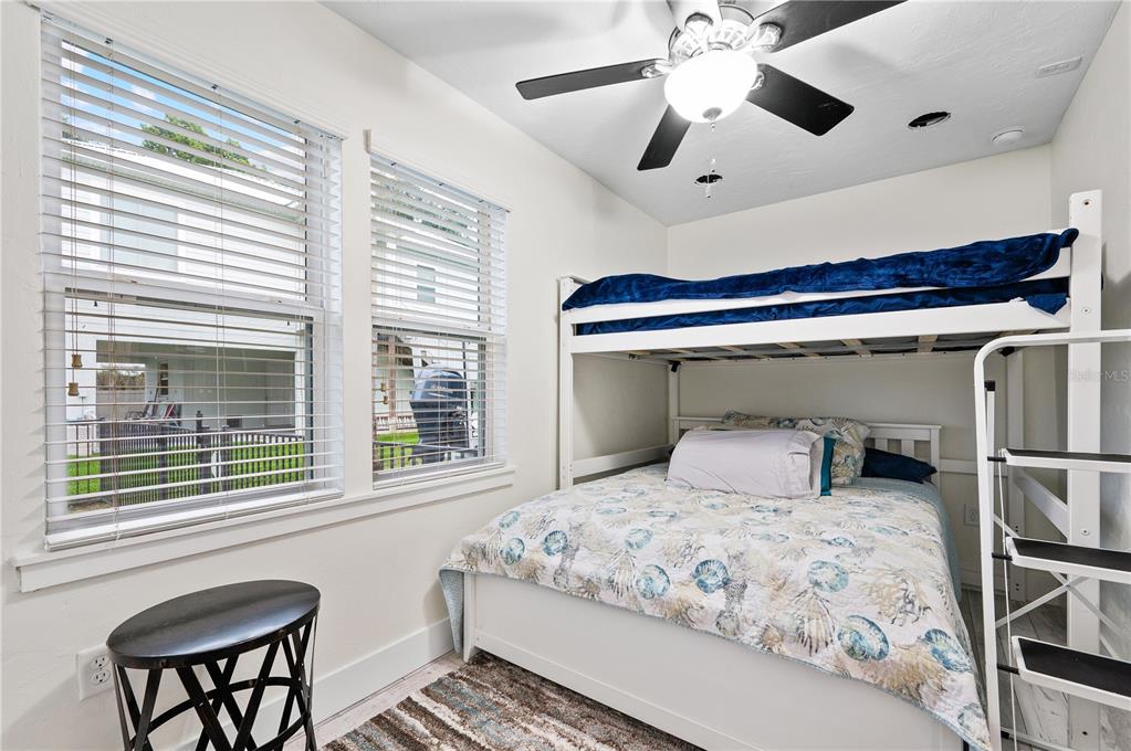 30 Southeast Valare Lane, Unit 102B Crystal River, FL 34429 - Photo 6 of 47 a bedroom with a large bed and a chandelier