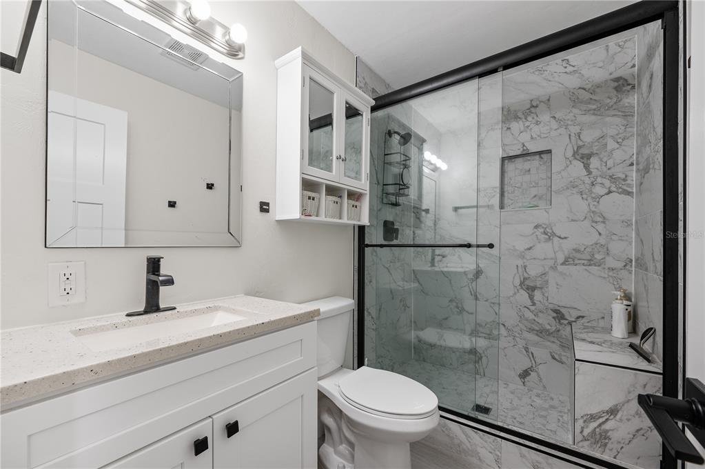 30 Southeast Valare Lane, Unit 102B Crystal River, FL 34429 - Photo 8 of 47 a bathroom with a shower sink vanity mirror and toilet