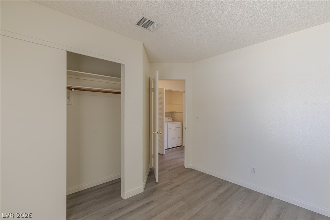 2803 Mirage Road Henderson, NV 89074 - Photo 25 of 39 A spacious bedroom offers a built-in closet and smooth wood-style flooring.