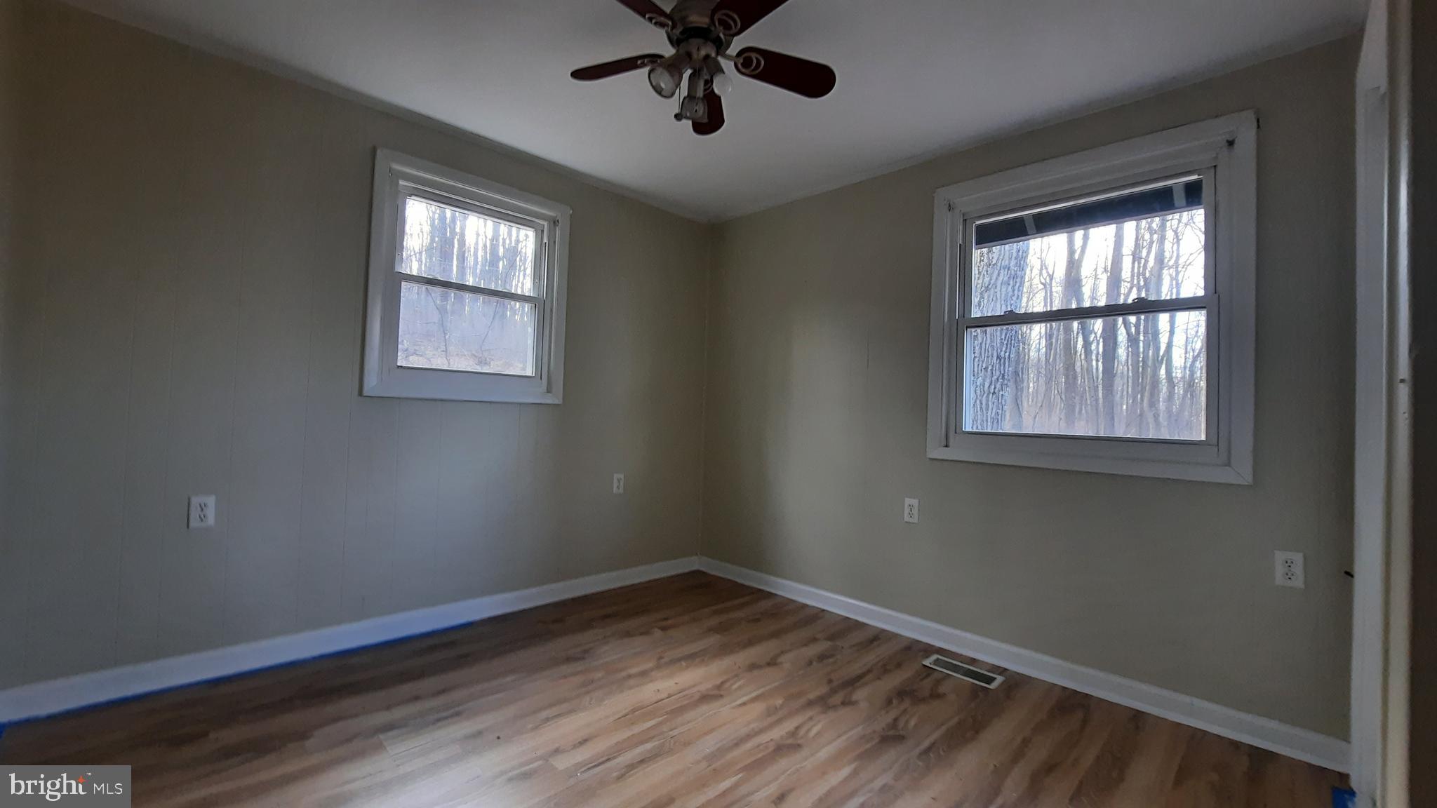 461 Chipmunk Trail Lane Linden, VA 22642 - Photo 11 of 26 a view of empty room with wooden floor and fan