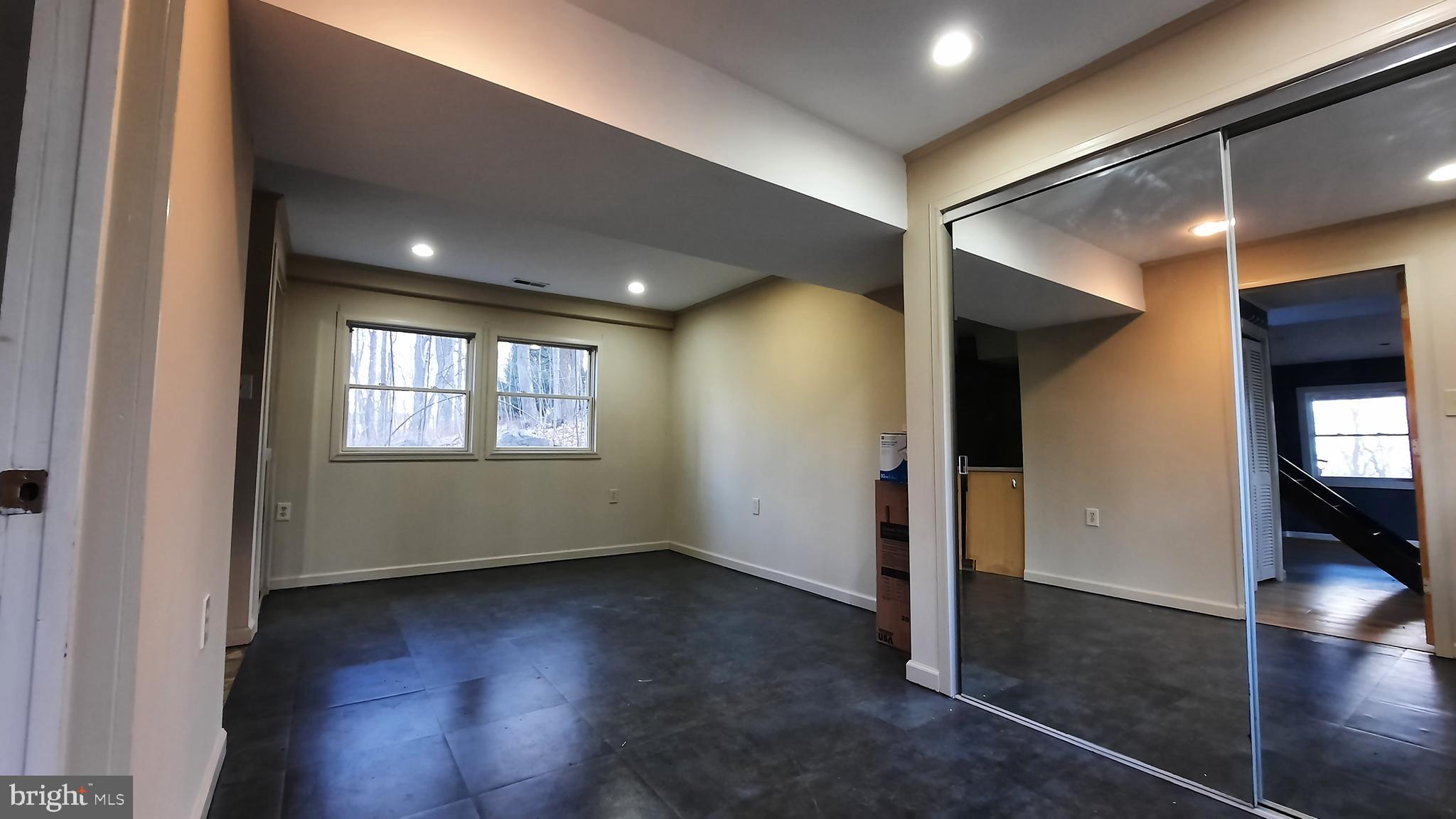 461 Chipmunk Trail Lane Linden, VA 22642 - Photo 20 of 26 an empty room with wooden floor and windows