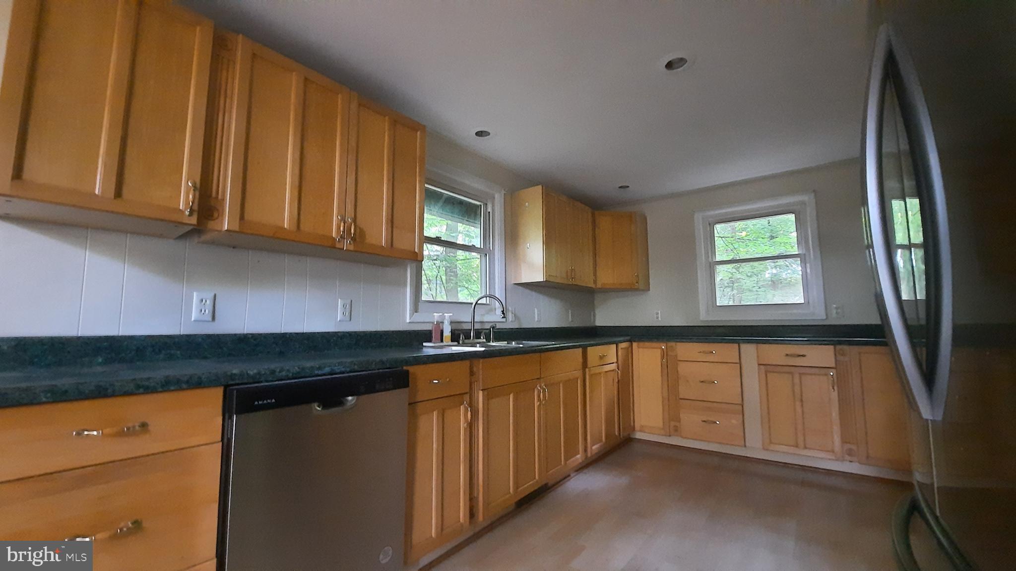 461 Chipmunk Trail Lane Linden, VA 22642 - Photo 8 of 26 a kitchen with granite countertop stainless steel appliances a sink stove and cabinets