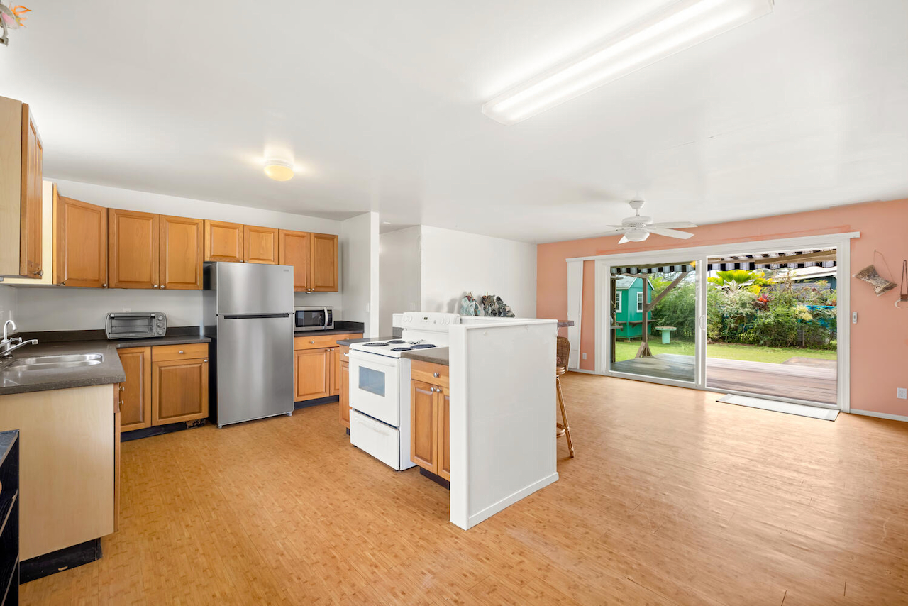 1010 Kealoha Road Kapaa, HI 96746 - Photo 8 of 30 a kitchen with refrigerator cabinets and wooden floor