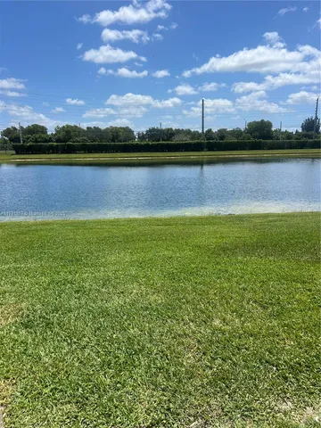 a view of a lake with houses in the background