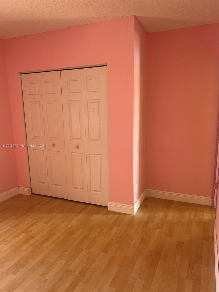 5357 Southwest 125th Avenue Miramar, FL 33027 - Photo 18 of 39 an empty room with wooden floor and cabinet