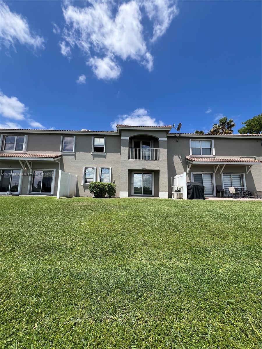 5357 Southwest 125th Avenue Miramar, FL 33027 - Photo 29 of 39 a front view of a house with a garden and yard