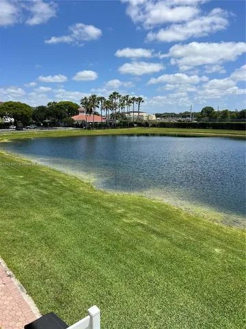 a view of a lake with houses in the back
