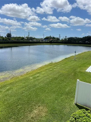 a view of a lake with houses in the back