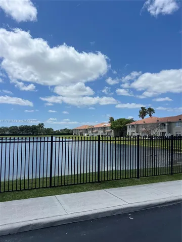 a view of a lake with houses in the back