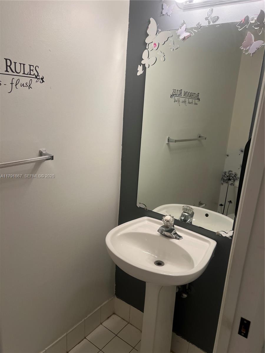 5357 Southwest 125th Avenue Miramar, FL 33027 - Photo 7 of 39 a bathroom with a sink and mirror