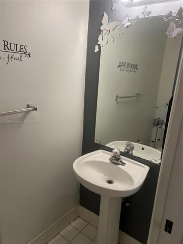 a bathroom with a sink and mirror
