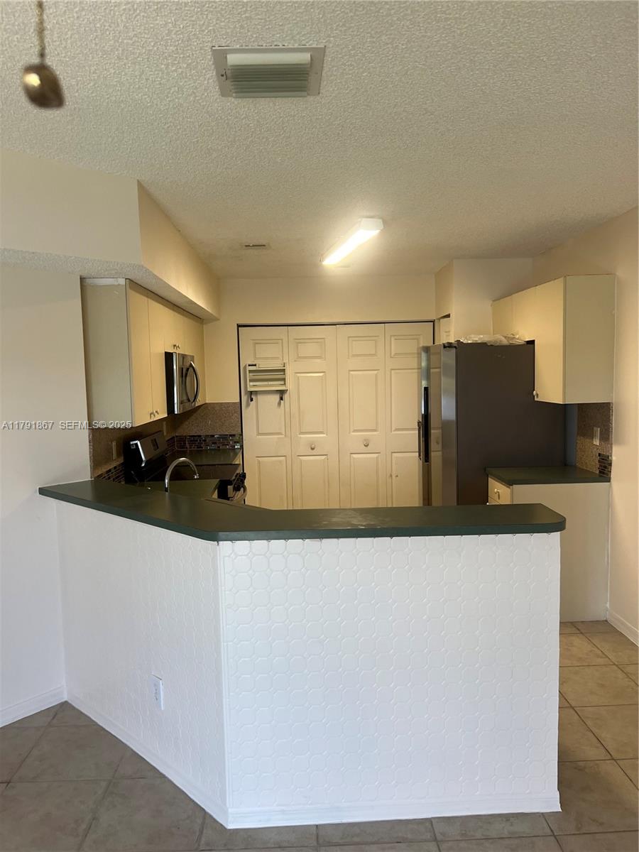 5357 Southwest 125th Avenue Miramar, FL 33027 - Photo 10 of 39 a kitchen with stainless steel appliances granite countertop a refrigerator and a sink