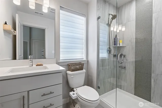 a bathroom with a glass shower door