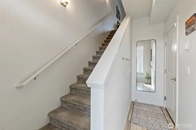 a view of an entryway with wooden floor