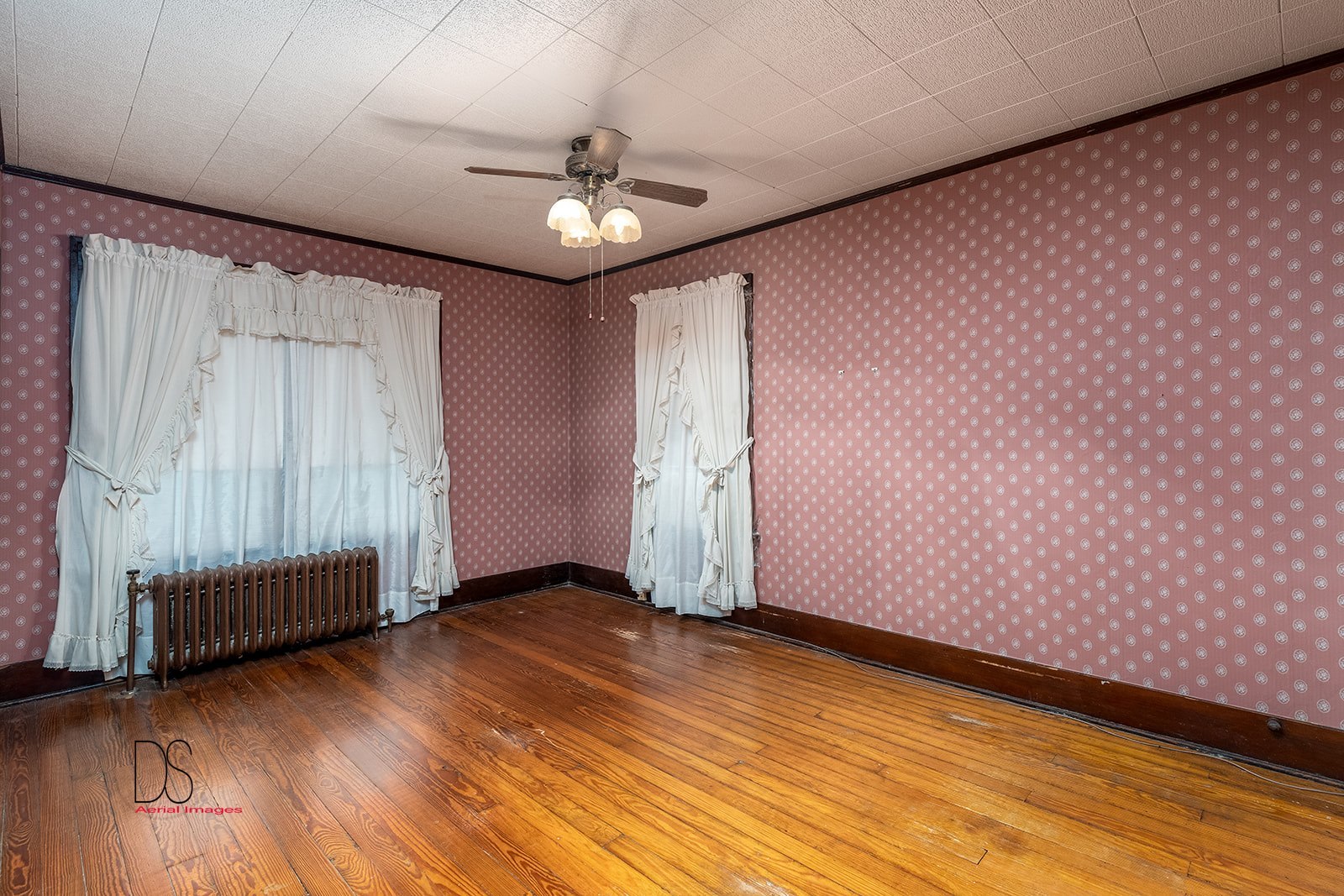1006 North 2401st Road Ottawa, IL 61350 - Photo 19 of 35 an empty room with wooden floor chandelier fan and windows