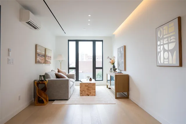 a living room with furniture and large windows
