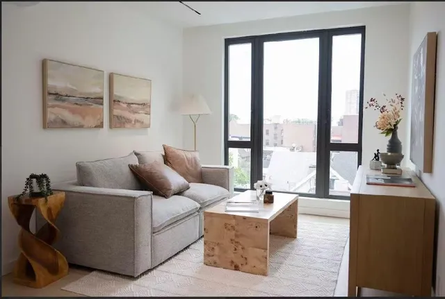 a living room with furniture and large windows