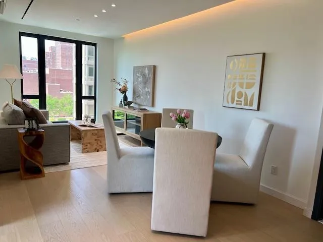 a living room with furniture and large window