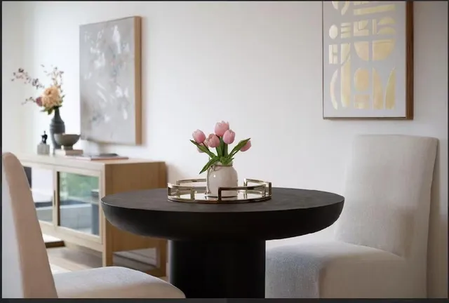 a dining room with furniture and wooden floor