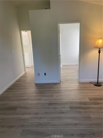 a view of a room with wooden floor