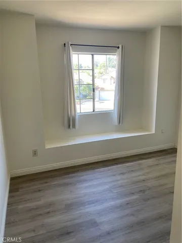 a view of room with window and hardwood floor