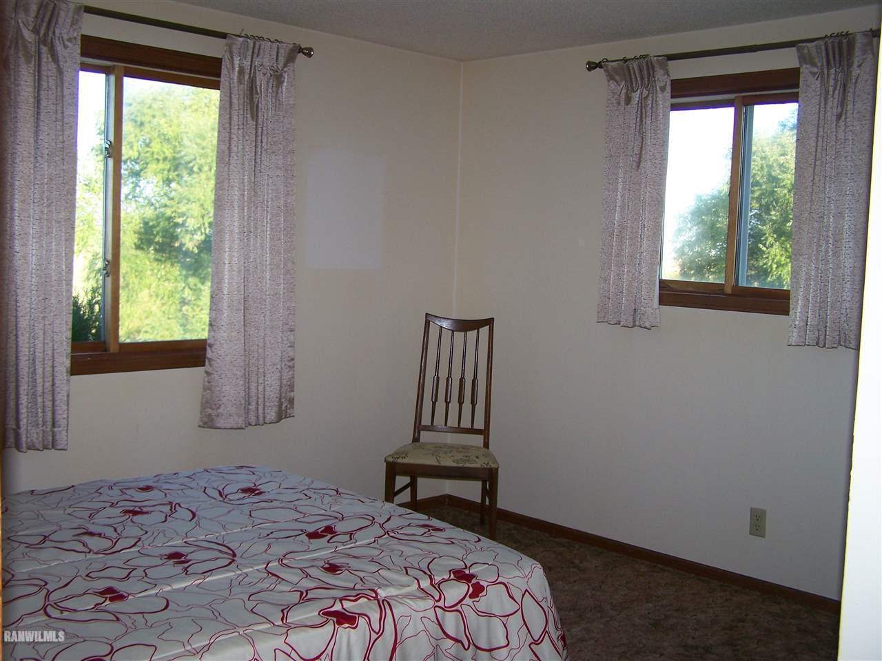 9833 Becker Road Savanna, IL 61074 - Photo 13 of 25 a bedroom with a bed and a window