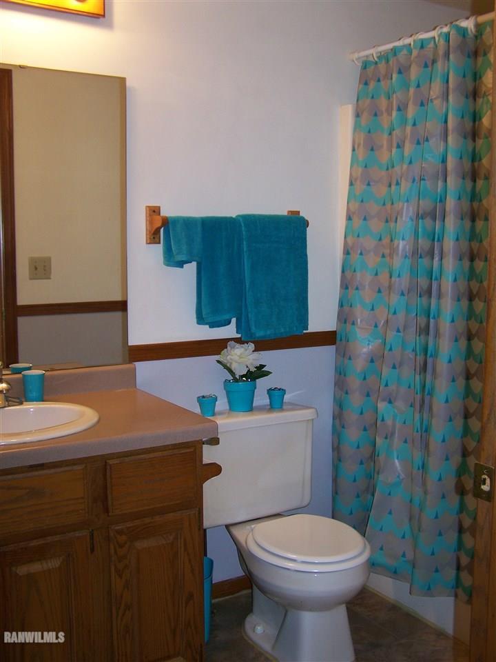 9833 Becker Road Savanna, IL 61074 - Photo 17 of 25 a bathroom with a sink toilet and mirror