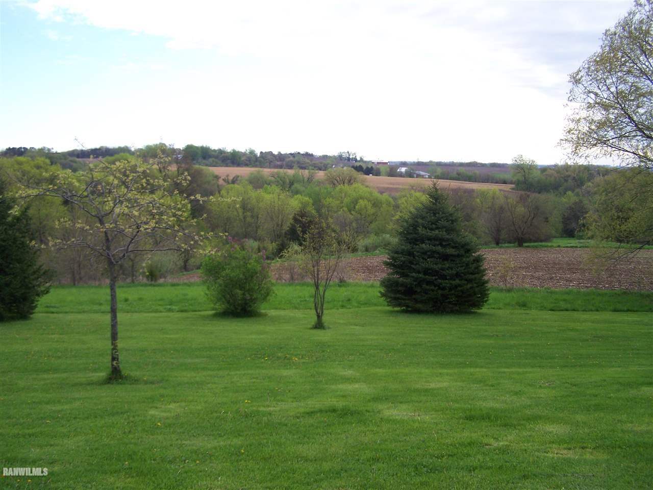9833 Becker Road Savanna, IL 61074 - Photo 23 of 25 a view of a grassy field with trees in the background