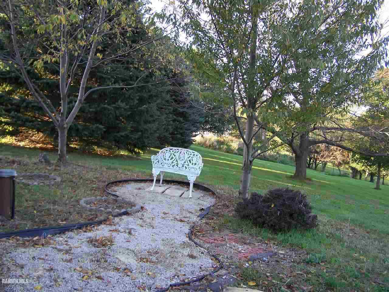 9833 Becker Road Savanna, IL 61074 - Photo 4 of 25 a view of a bench in the garden