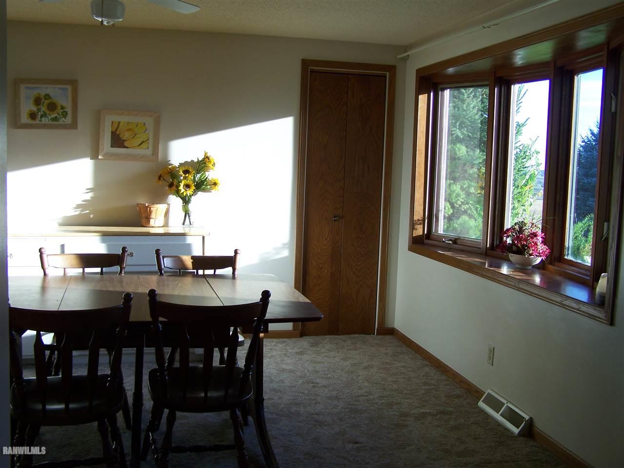 9833 Becker Road Savanna, IL 61074 - Photo 9 of 25 a view of a dining room with furniture and window