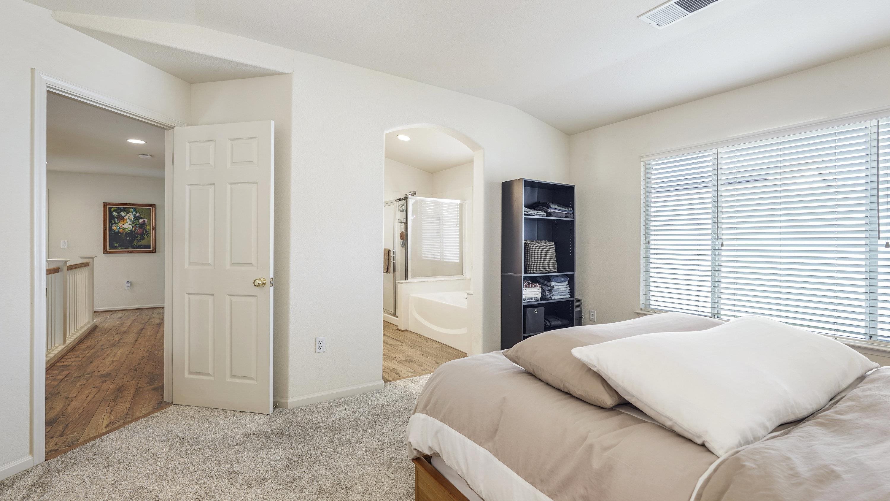 1388 Four Oaks Road San Jose, CA 95131 - Photo 20 of 47 a bedroom with a large bed and walk in closet