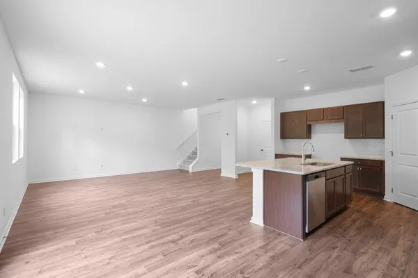 a view of kitchen with microwave and cabinets