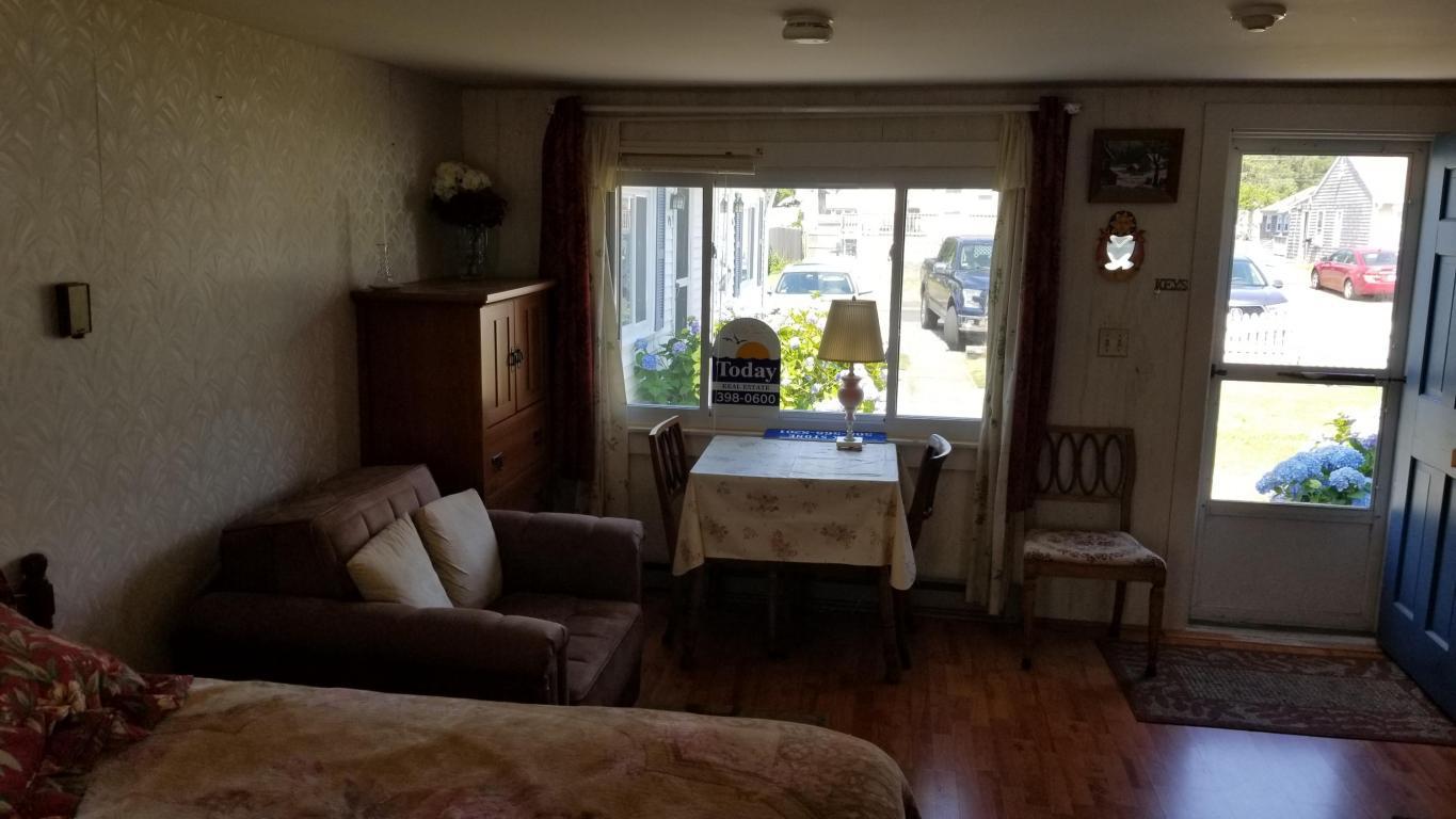 174 Captain Chase Road, Unit 17 Dennis, MA 02639 - Photo 2 of 11 a living room with furniture and a window