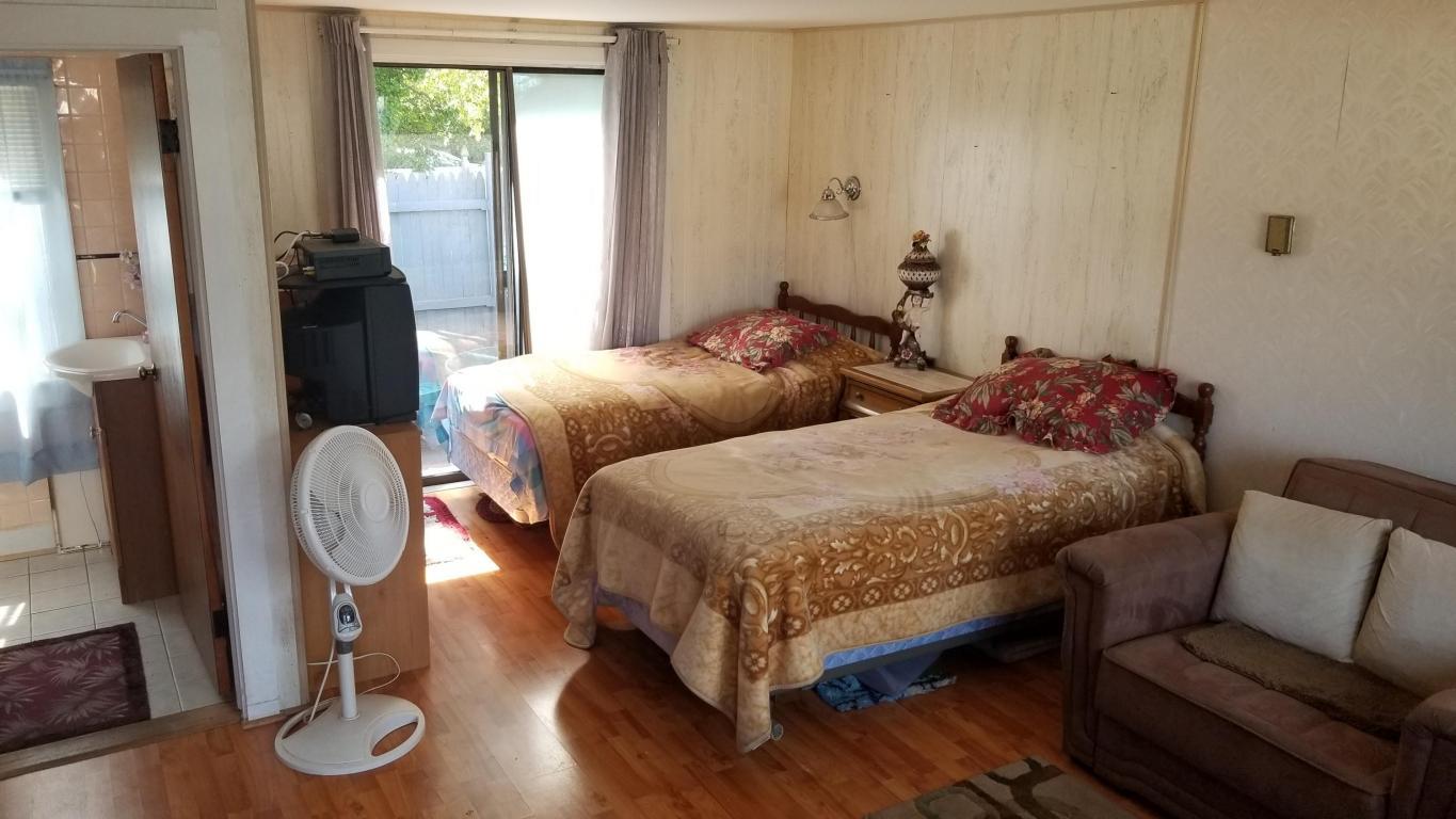 174 Captain Chase Road, Unit 17 Dennis, MA 02639 - Photo 3 of 11 a bedroom with two beds and wooden floor