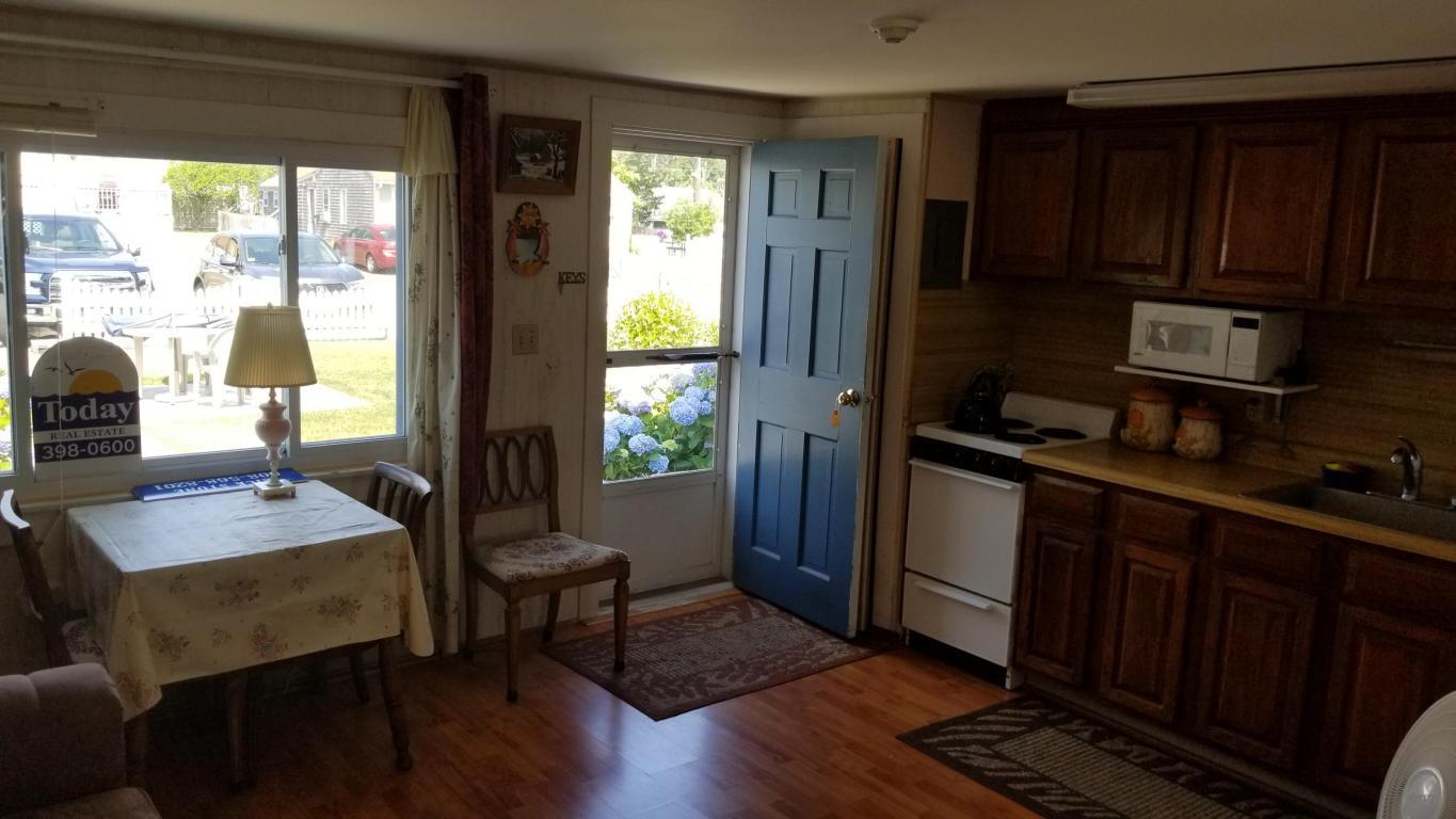 174 Captain Chase Road, Unit 17 Dennis, MA 02639 - Photo 5 of 11 a kitchen with sink and refrigerator