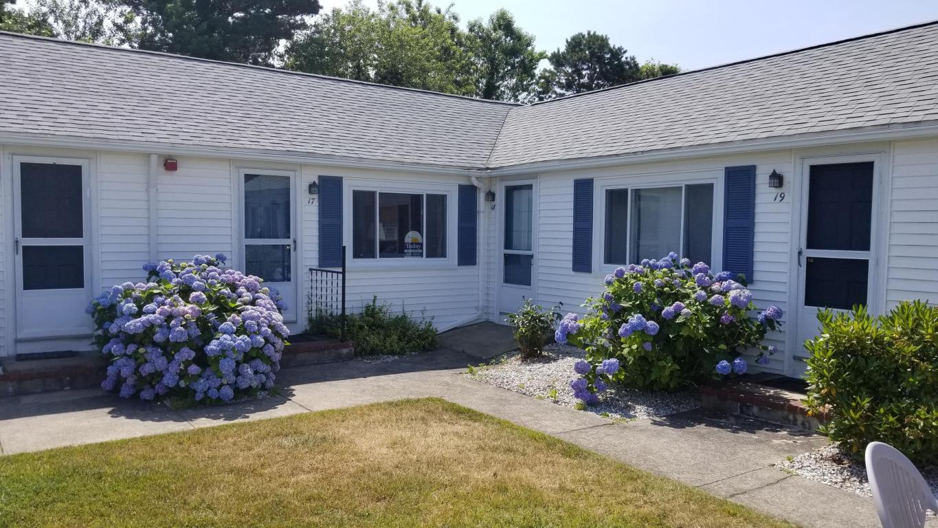 174 Captain Chase Road, Unit 17 Dennis, MA 02639 - Photo 6 of 11 a front view of a house with a yard and potted plants