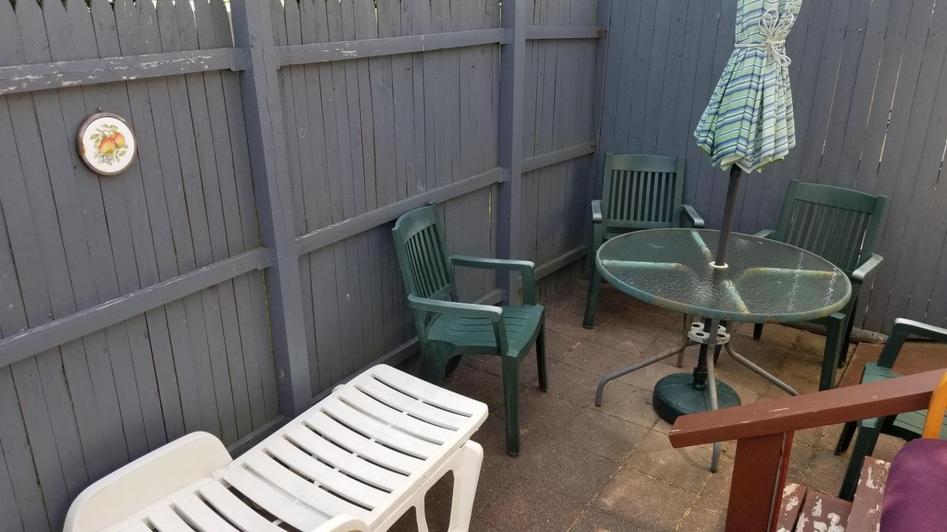 174 Captain Chase Road, Unit 17 Dennis, MA 02639 - Photo 7 of 11 a balcony view with a table and chairs