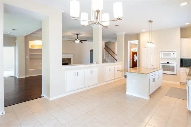 a large white kitchen with cabinets