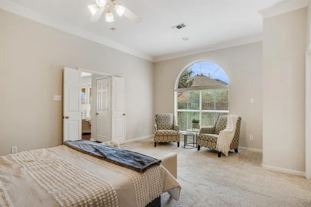a bedroom with furniture and a large window