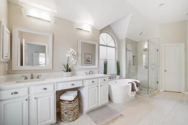 a spacious bathroom with a double vanity sink mirror and double