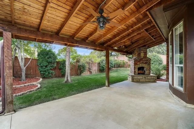 a view of a backyard with porch and garden