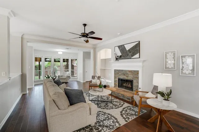 a living room with furniture fireplace and a large window