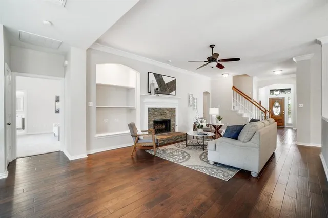 a living room with furniture fireplace and wooden floor